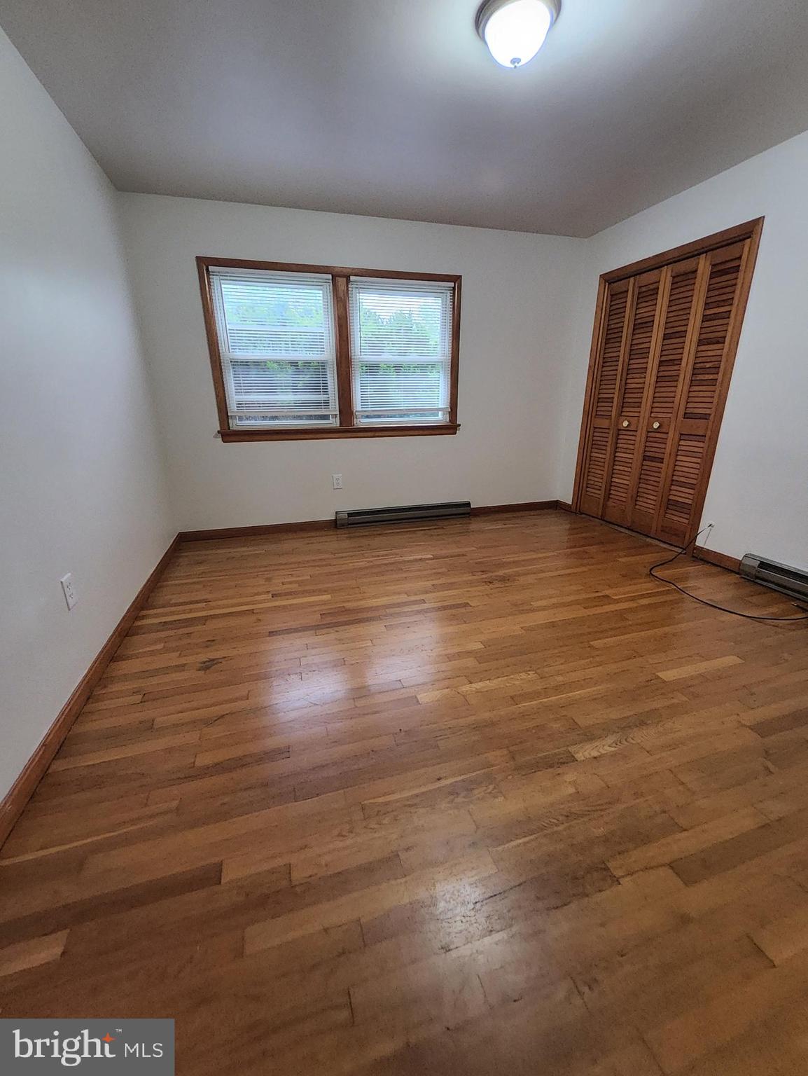 415 View Town Road Amissville, VA 20106 - Photo 16 of 19 a view of an empty room with wooden floor and a window