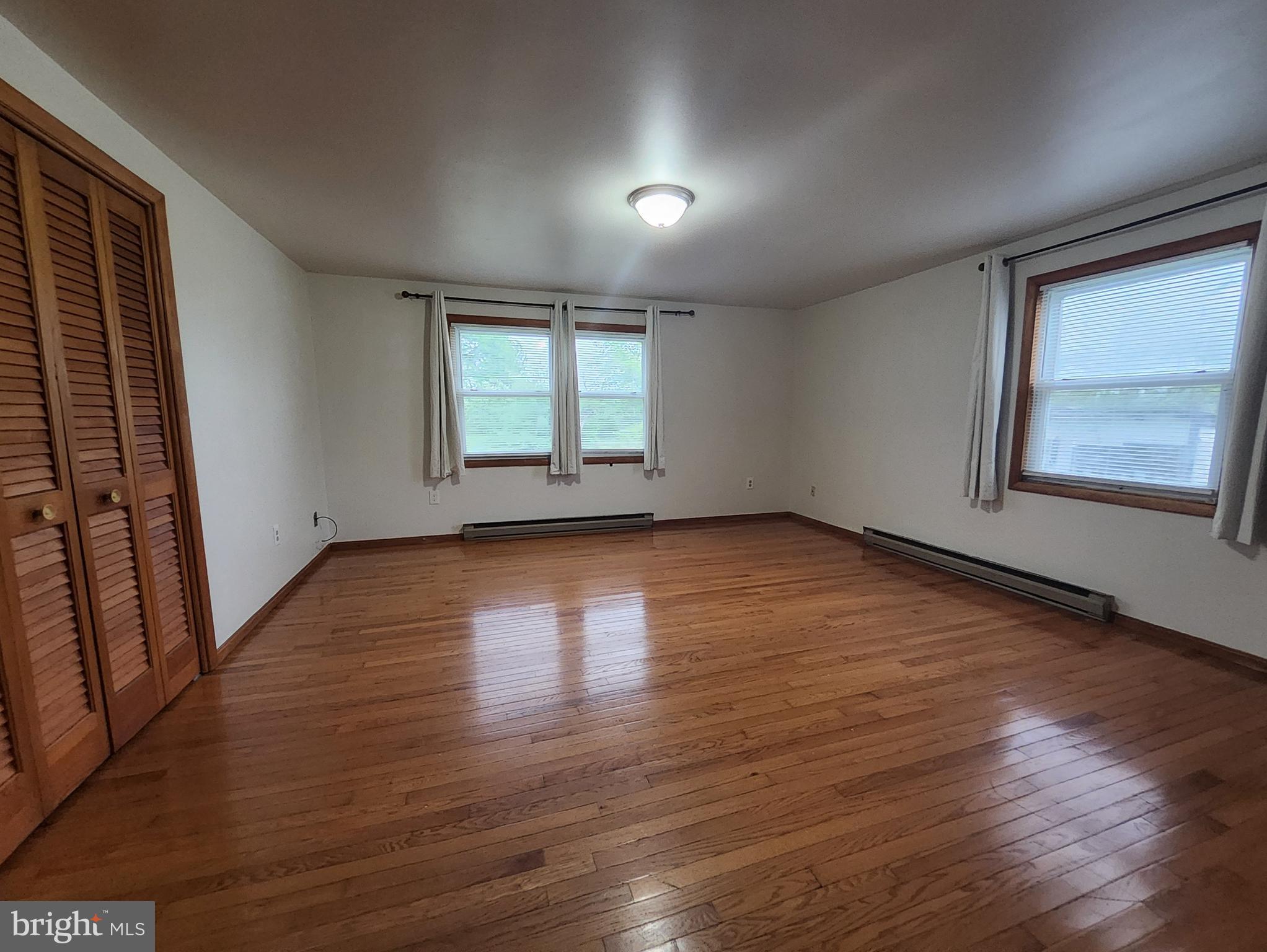 415 View Town Road Amissville, VA 20106 - Photo 7 of 19 an empty room with wooden floor and windows