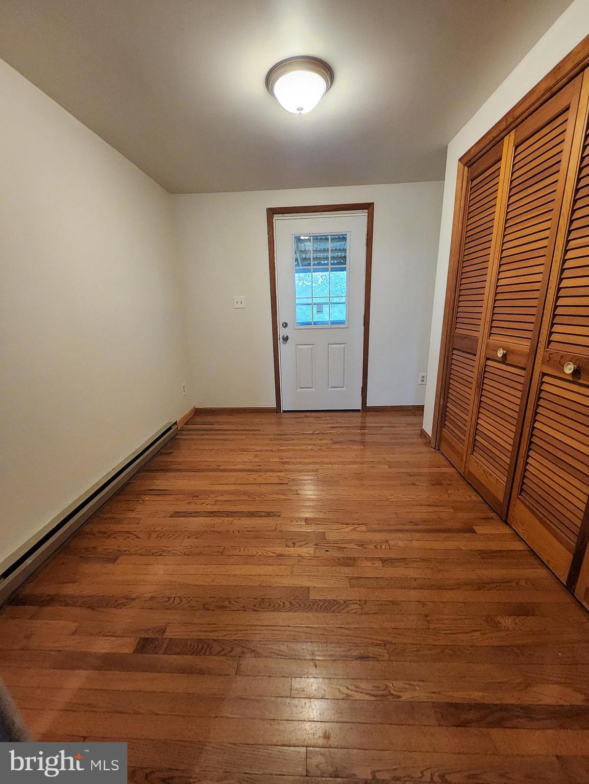 415 View Town Road Amissville, VA 20106 - Photo 10 of 19 an empty room with wooden floor and windows