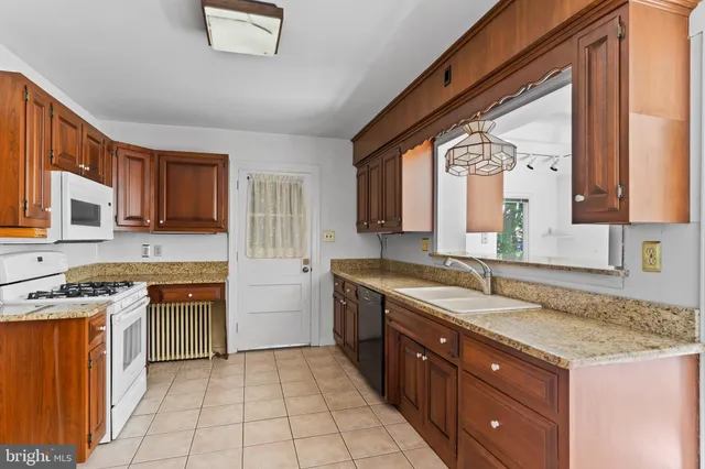 a kitchen with granite countertop a sink and a stove