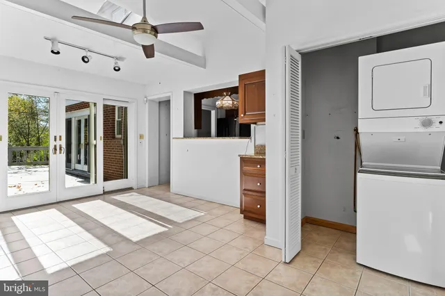 a view of a room with a window and ceiling fan