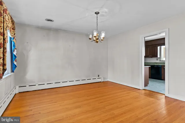 a kitchen with stainless steel appliances kitchen island granite countertop a refrigerator stove top oven and sink