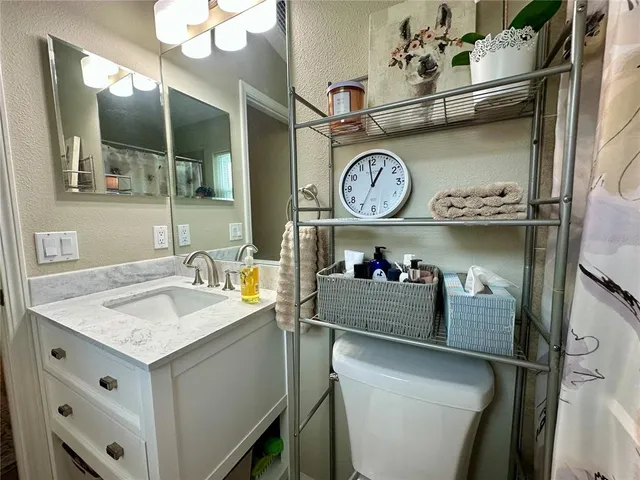 a white toilet sitting next to a shower curtain