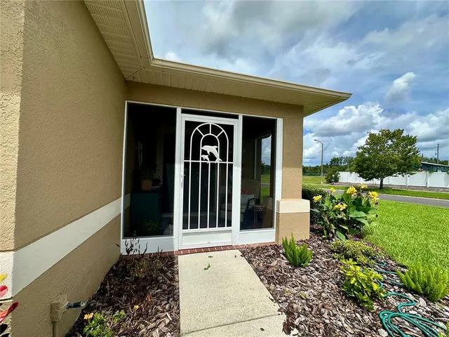 a view of a house with a large window and yard
