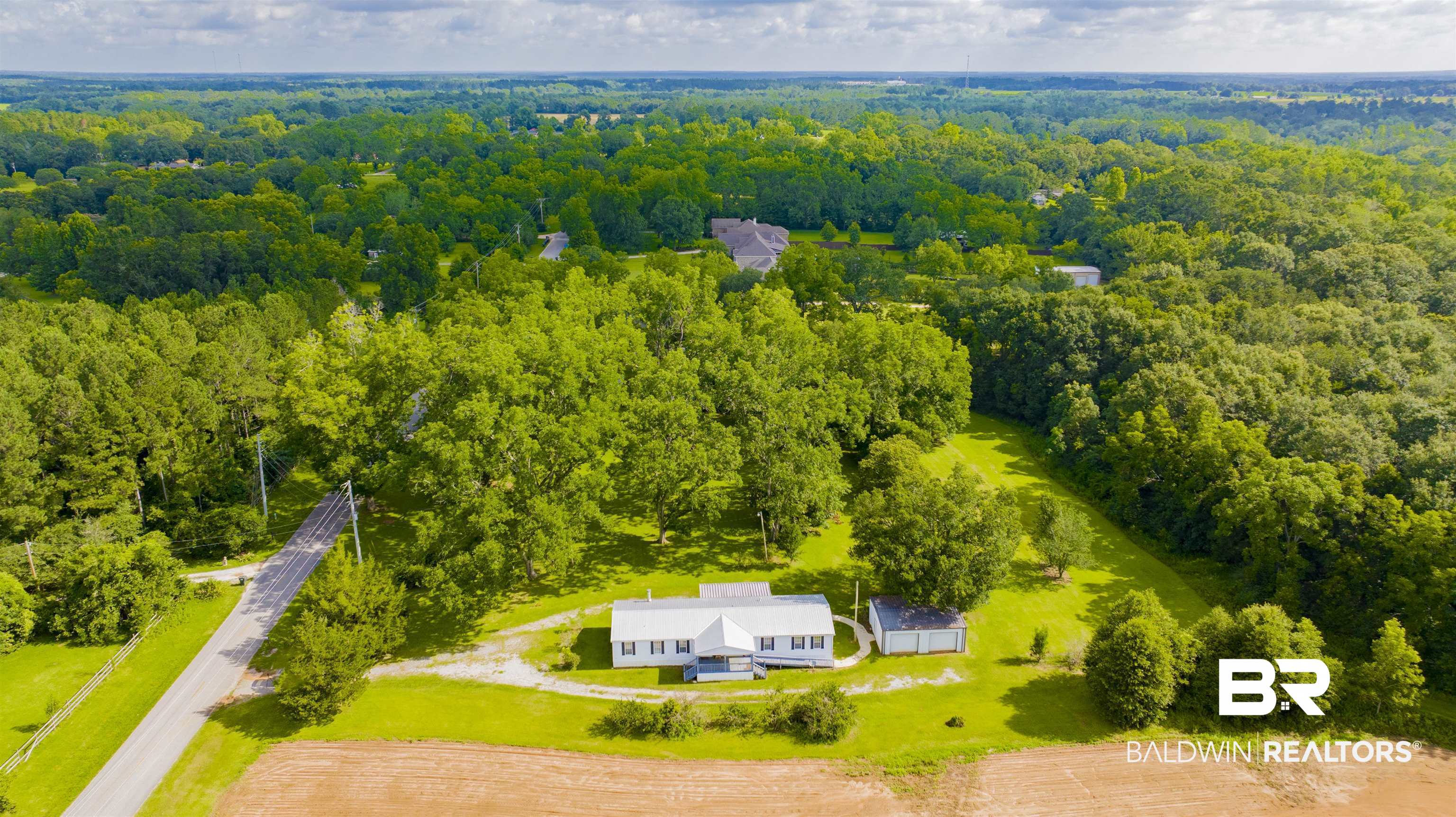 25700 County Road 71 Robertsdale, AL 36567 - Photo 39 of 40 Aerial view of property and surrounding area featuring a heavily wooded area