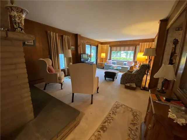 a view of a livingroom with furniture and a window