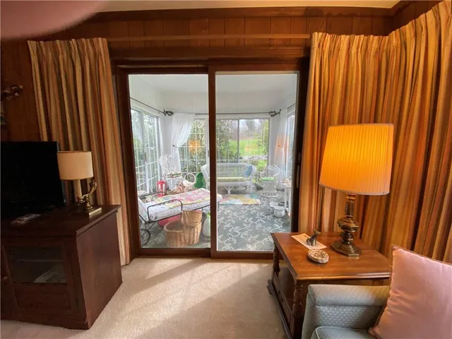 a living room with furniture and a balcony