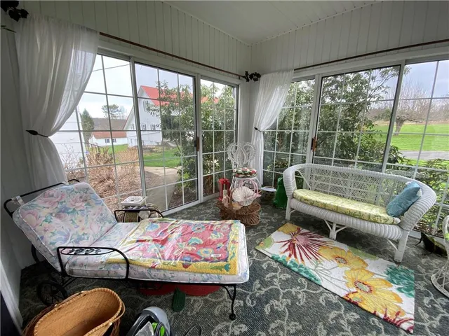a living room with furniture and a floor to ceiling window