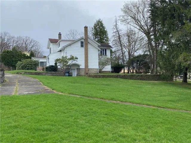 a front view of house with yard and green space