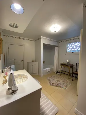 a bathroom with a sink a toilet and a mirror