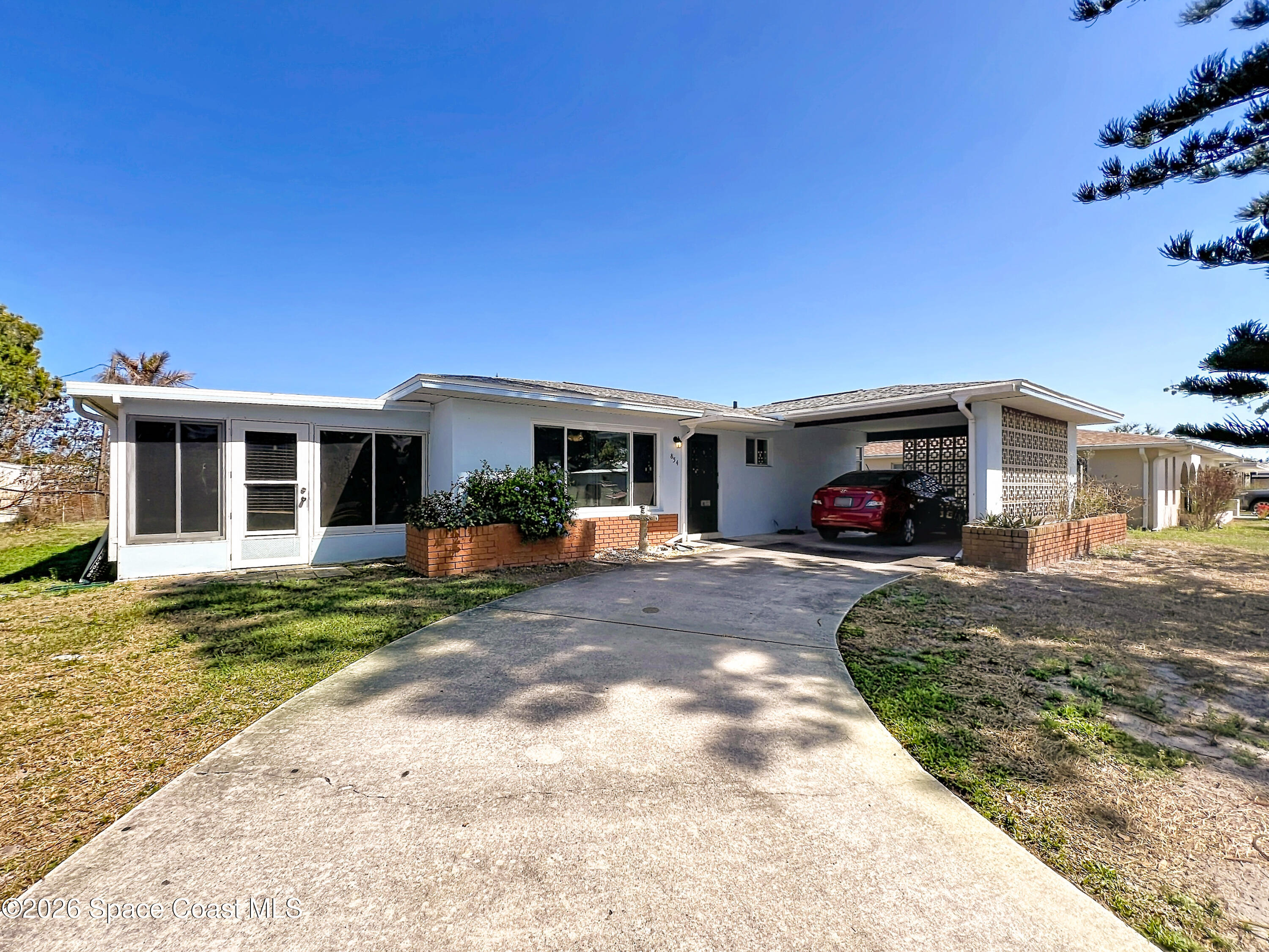 854 Angle Street Northeast Palm Bay, FL 32905 - Photo 1 of 23 a view of a house with a patio