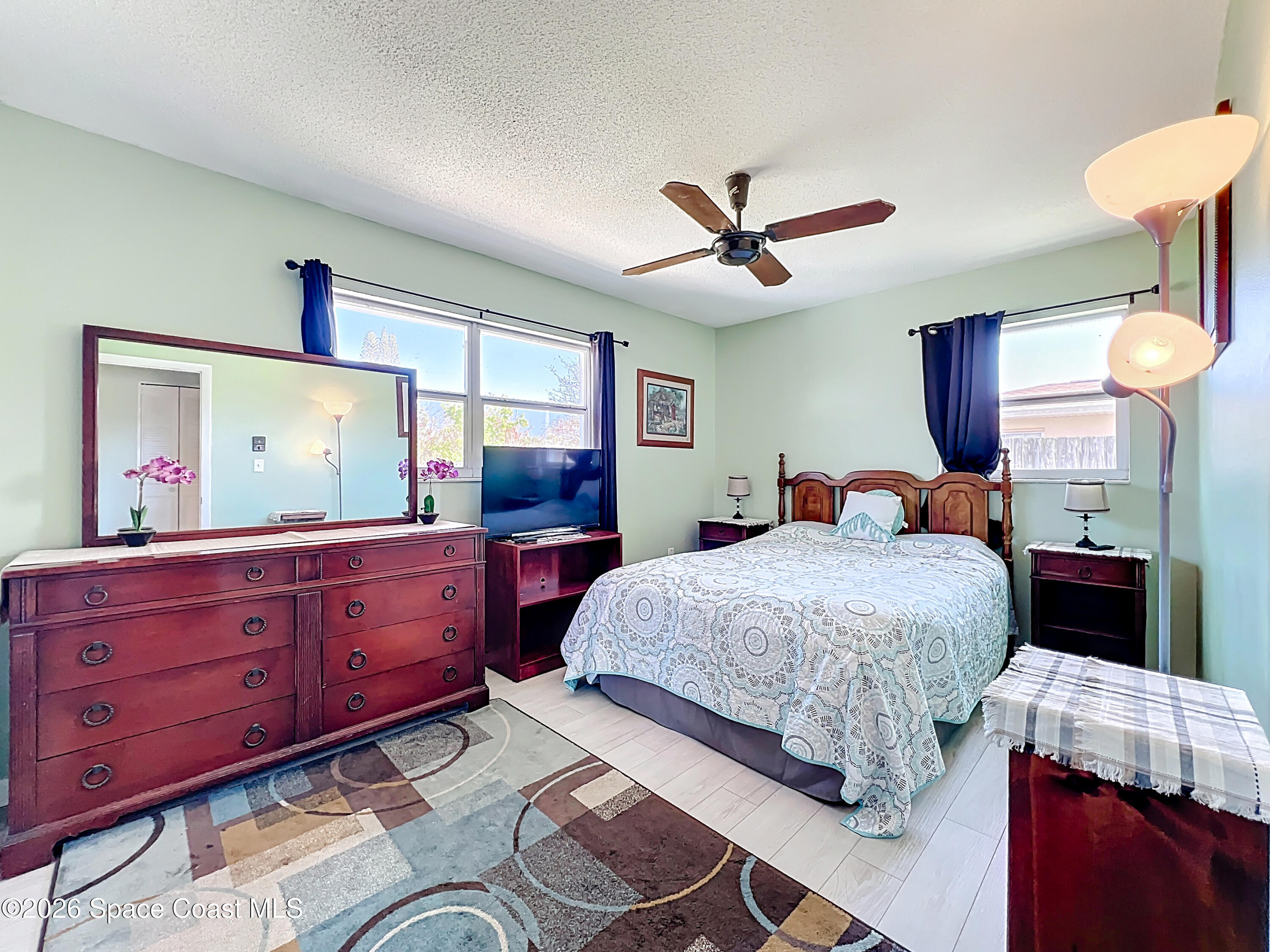 854 Angle Street Northeast Palm Bay, FL 32905 - Photo 13 of 23 a bedroom with a bed and a mirror on dresser