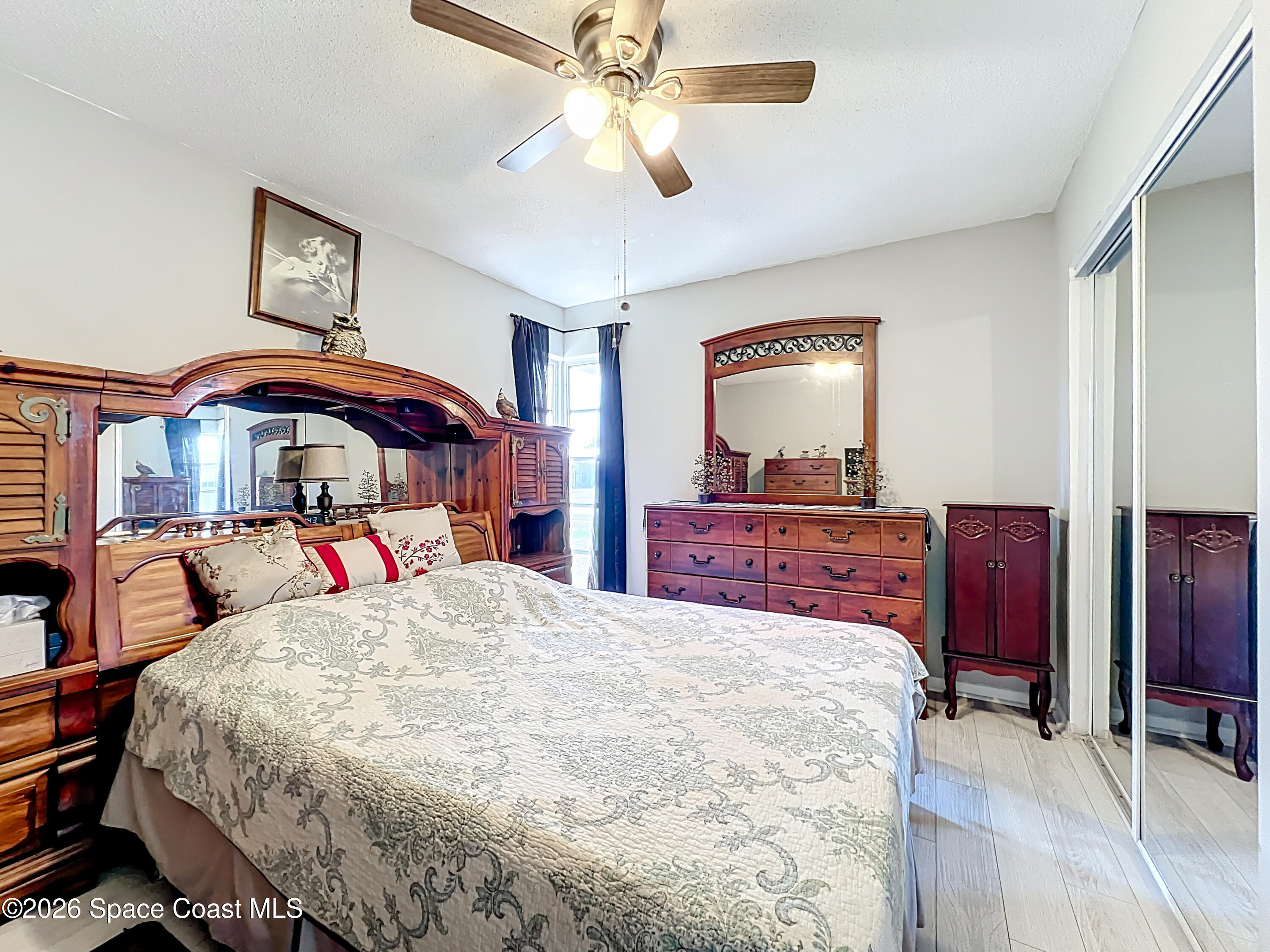 854 Angle Street Northeast Palm Bay, FL 32905 - Photo 14 of 23 a bedroom with a bed and a chandelier