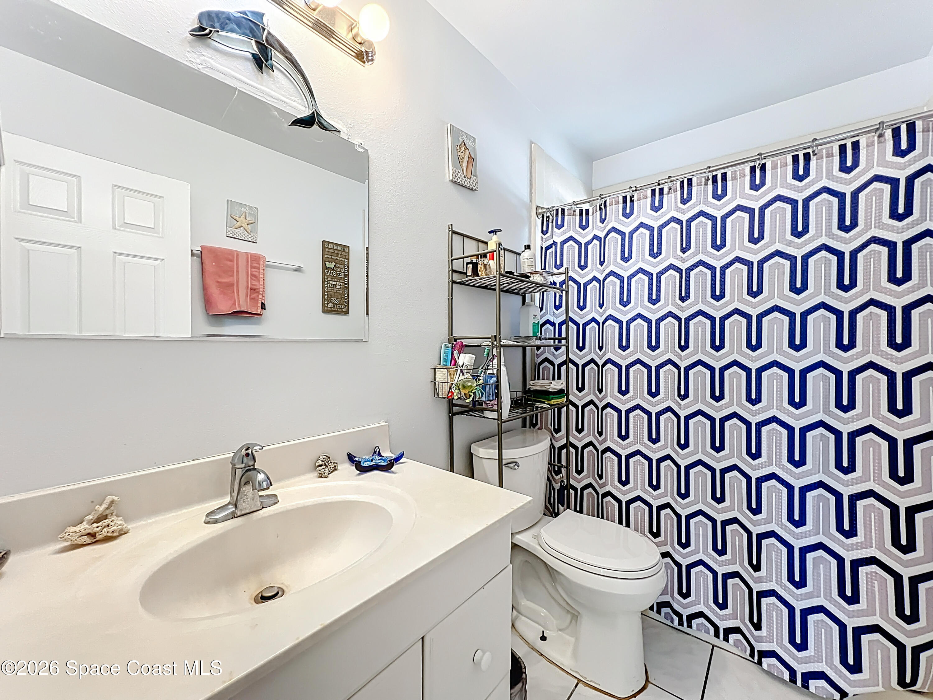 854 Angle Street Northeast Palm Bay, FL 32905 - Photo 15 of 23 a bathroom with a sink toilet and shower