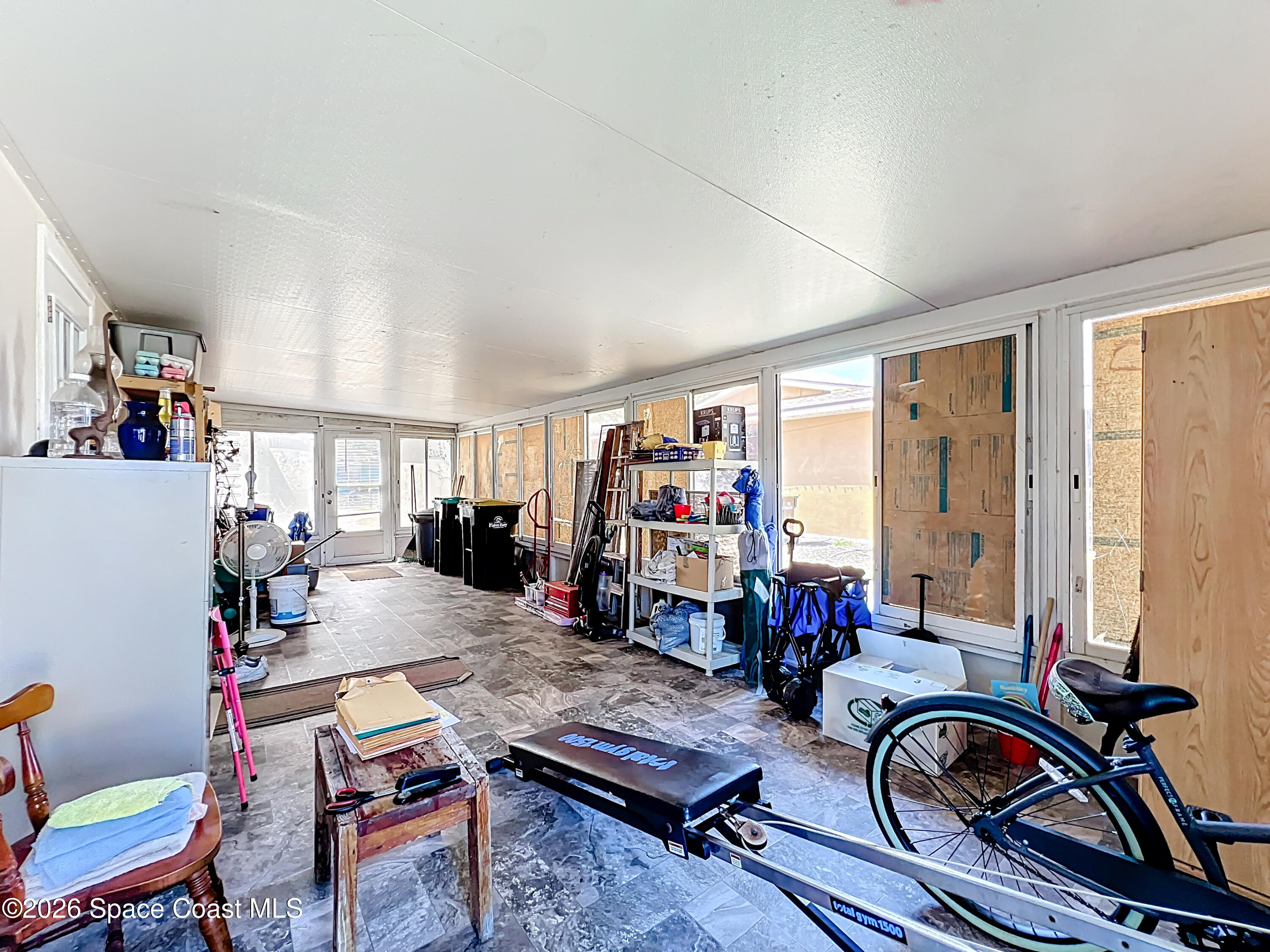 854 Angle Street Northeast Palm Bay, FL 32905 - Photo 19 of 23 a view of a livingroom with furniture gym equipment and a large window