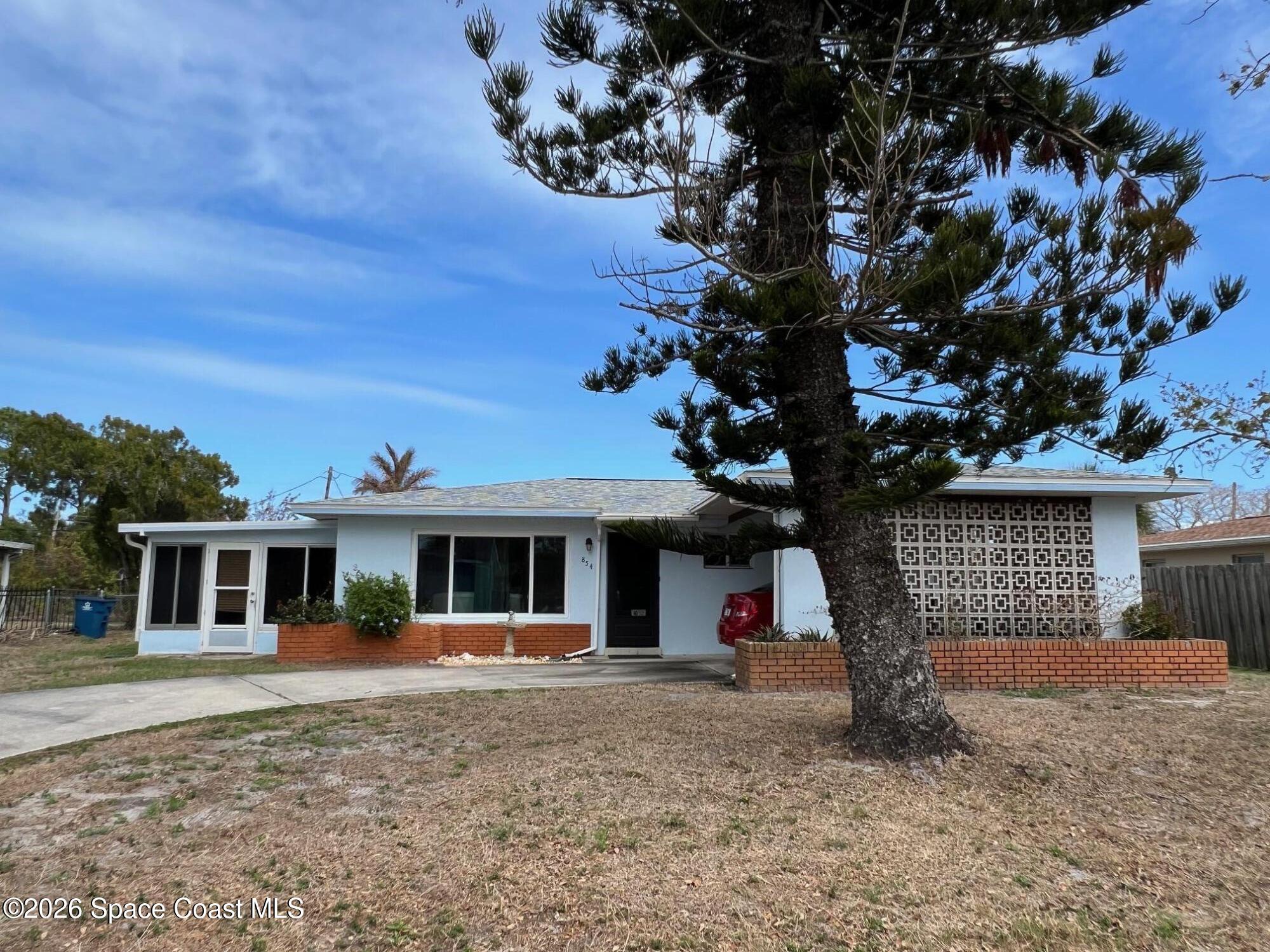 854 Angle Street Northeast Palm Bay, FL 32905 - Photo 3 of 23 front view of a house with a tree