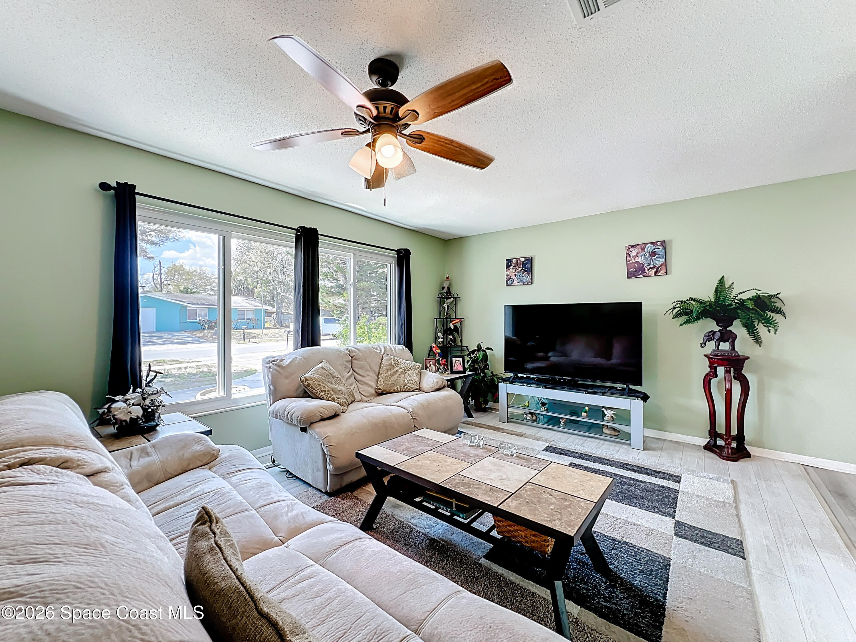 854 Angle Street Northeast Palm Bay, FL 32905 - Photo 8 of 23 a living room with furniture and a flat screen tv