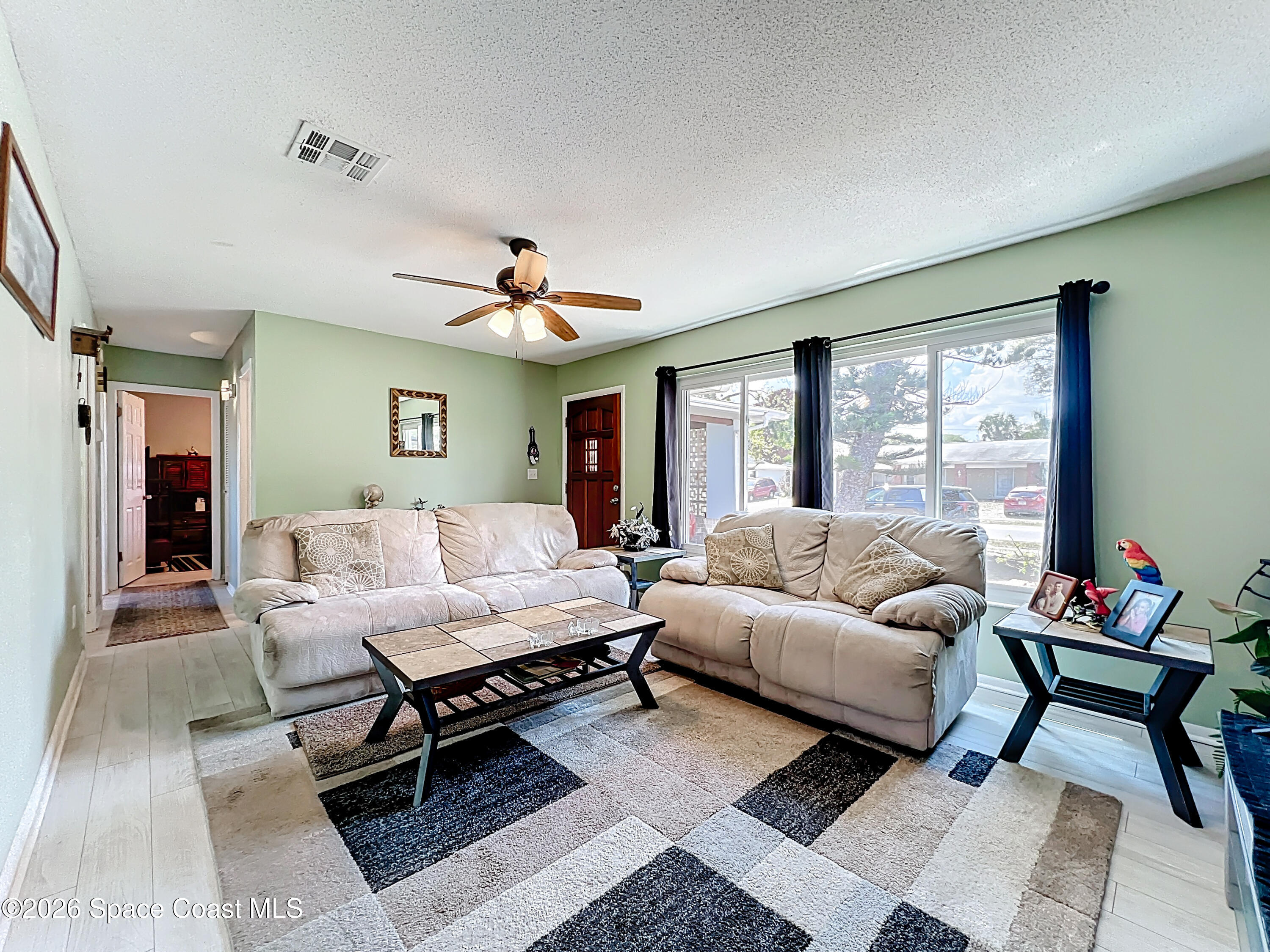 854 Angle Street Northeast Palm Bay, FL 32905 - Photo 9 of 23 a living room with furniture and a large window