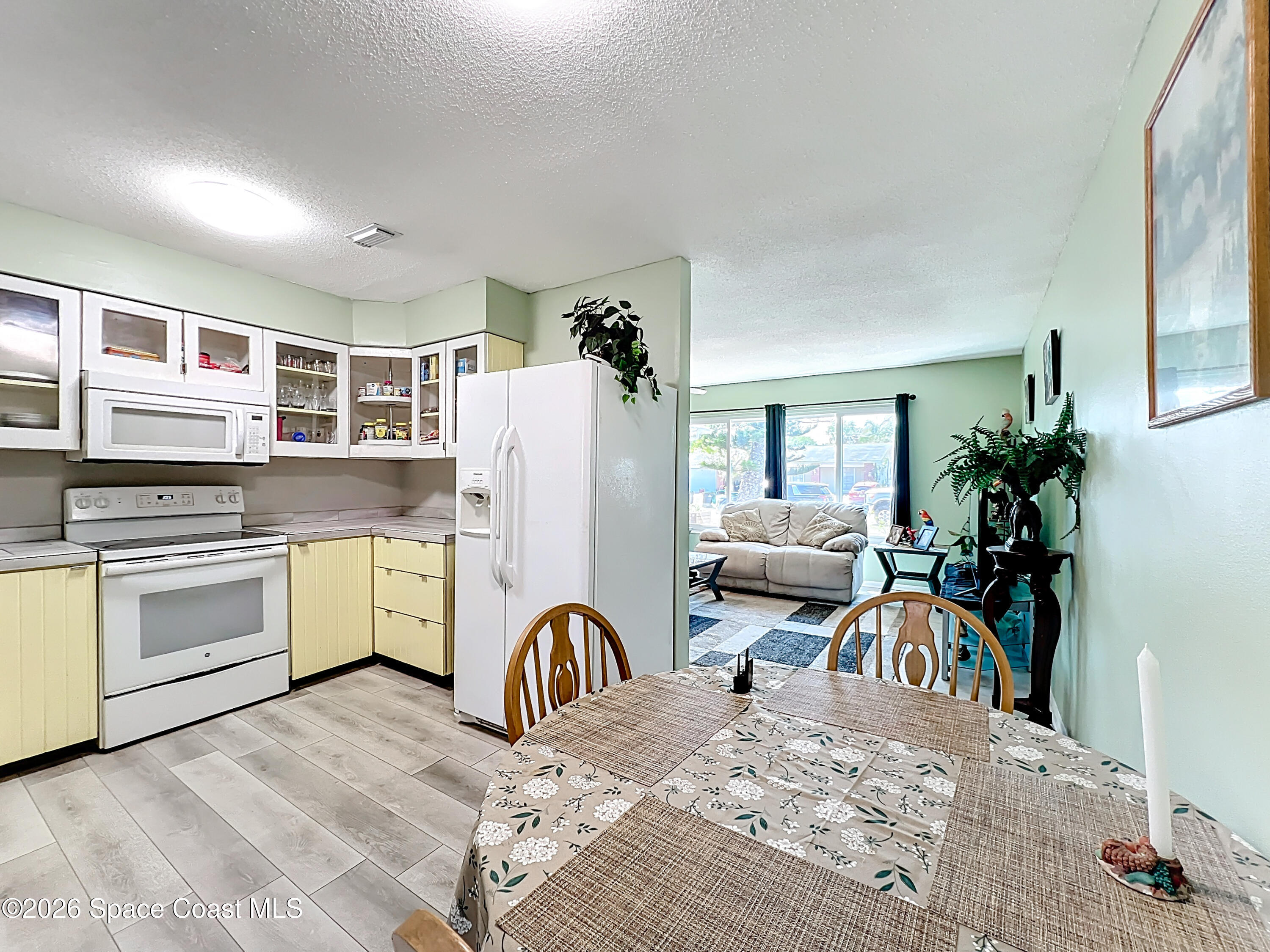 854 Angle Street Northeast Palm Bay, FL 32905 - Photo 10 of 23 a kitchen with a refrigerator and a stove top oven