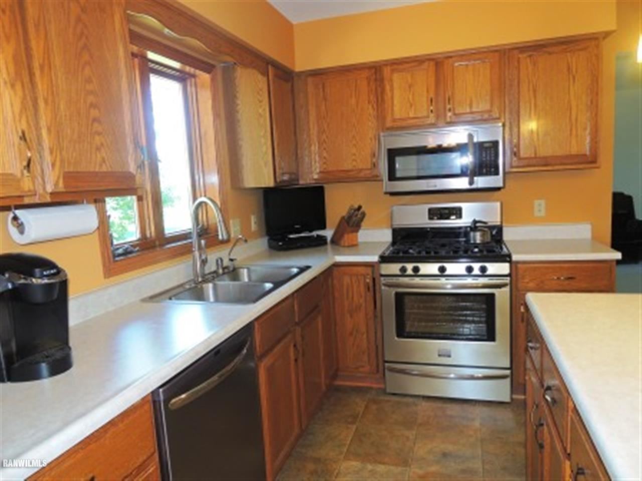 10730 East Rock Grove Road Davis, IL 61019 - Photo 2 of 12 a kitchen with stainless steel appliances a stove sink and microwave