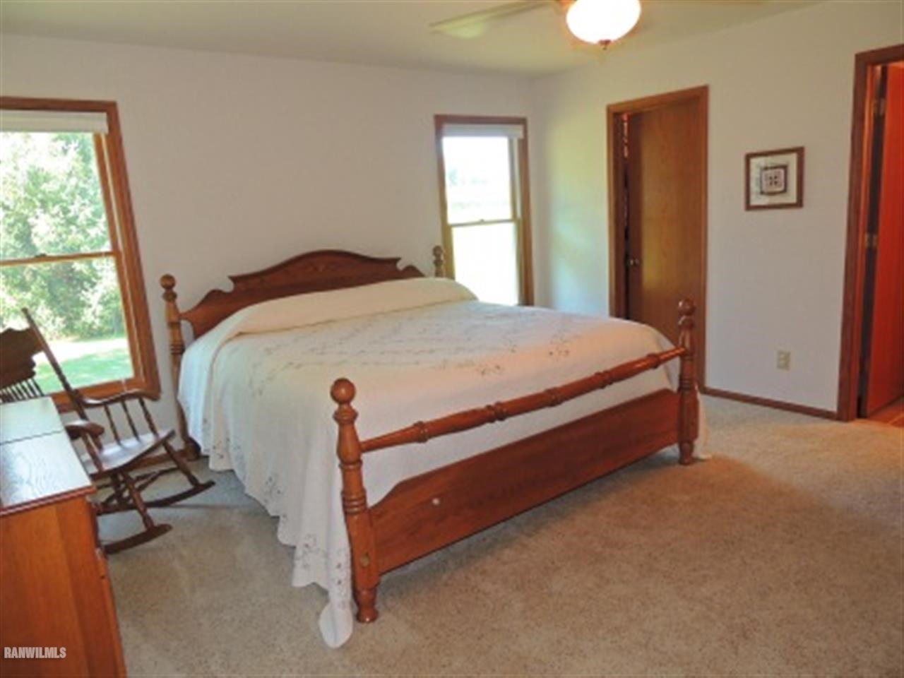 10730 East Rock Grove Road Davis, IL 61019 - Photo 5 of 12 a bed sitting in a bedroom next to a window