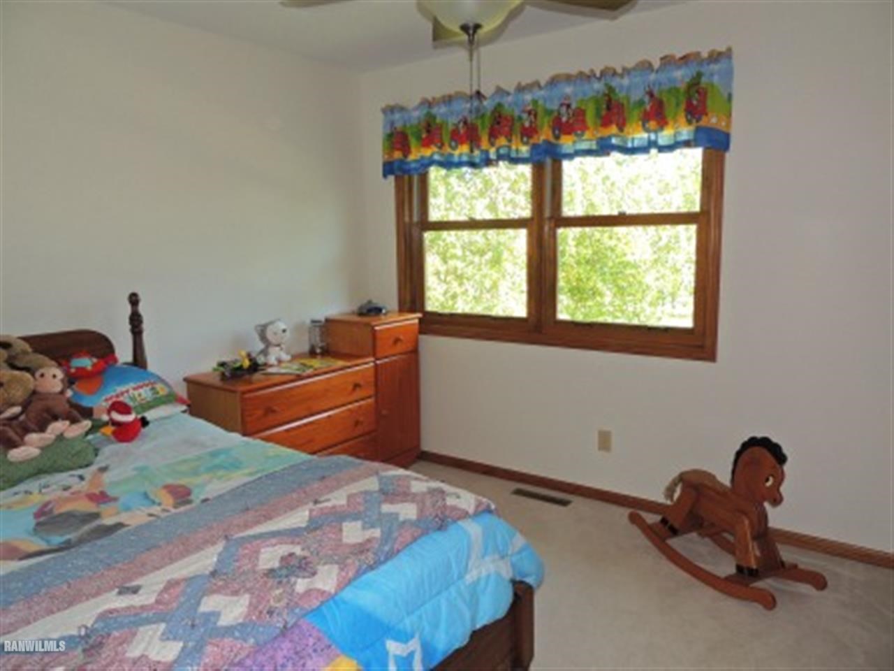 10730 East Rock Grove Road Davis, IL 61019 - Photo 6 of 12 a bedroom with bed and a window
