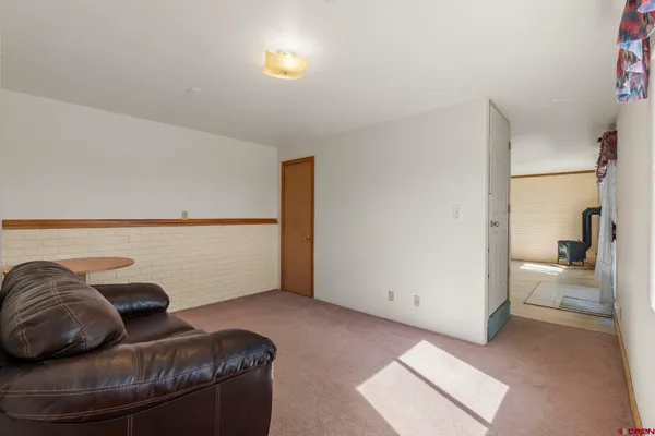 a living room with furniture and a walk in closet