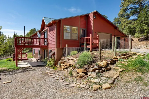 a view of a house with a yard and sitting area
