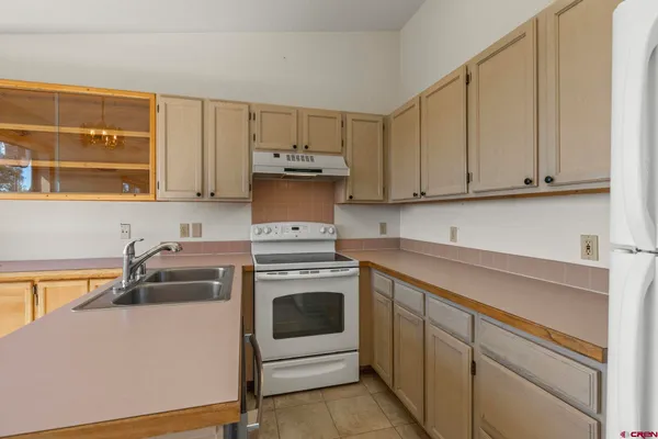 a kitchen with a sink and a stove top oven
