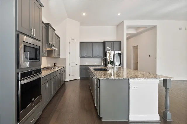 a view of a kitchen with a sink and a refrigerator