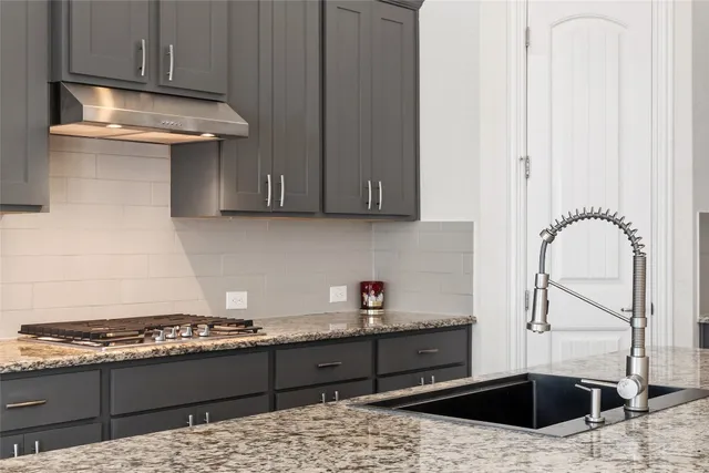an empty room with wooden floor and ceiling fan