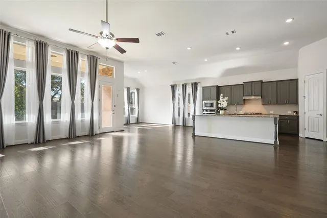a spacious bathroom with a bathtub sink and mirror