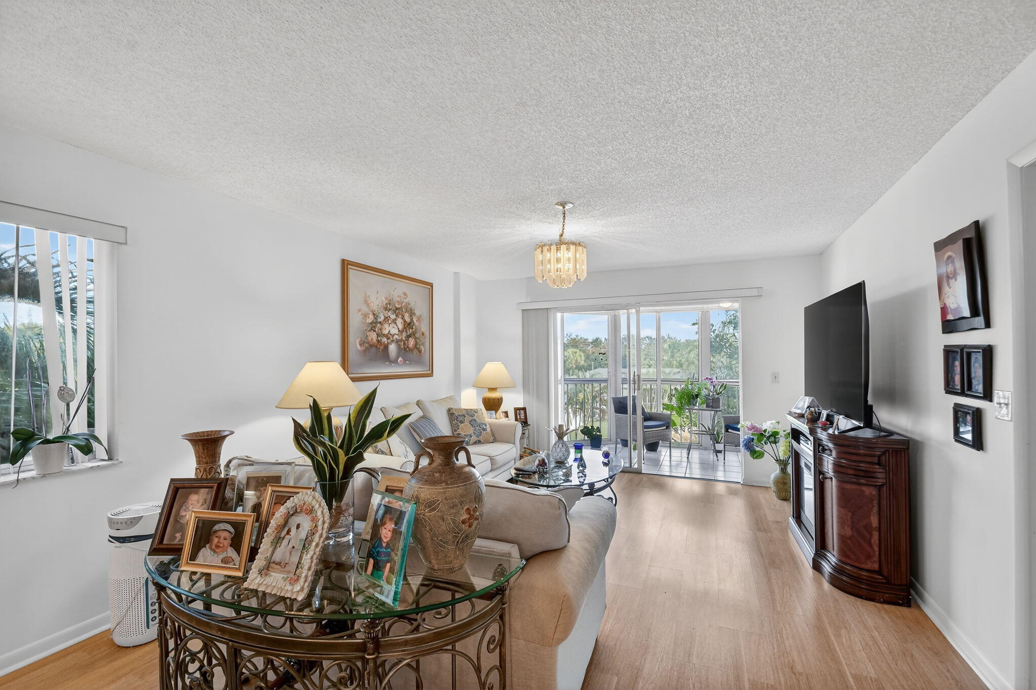 3146 Via Poinciana, Unit 301 Lake Worth, FL 33467 - Photo 11 of 23 a living room with furniture a flat screen tv and a large window