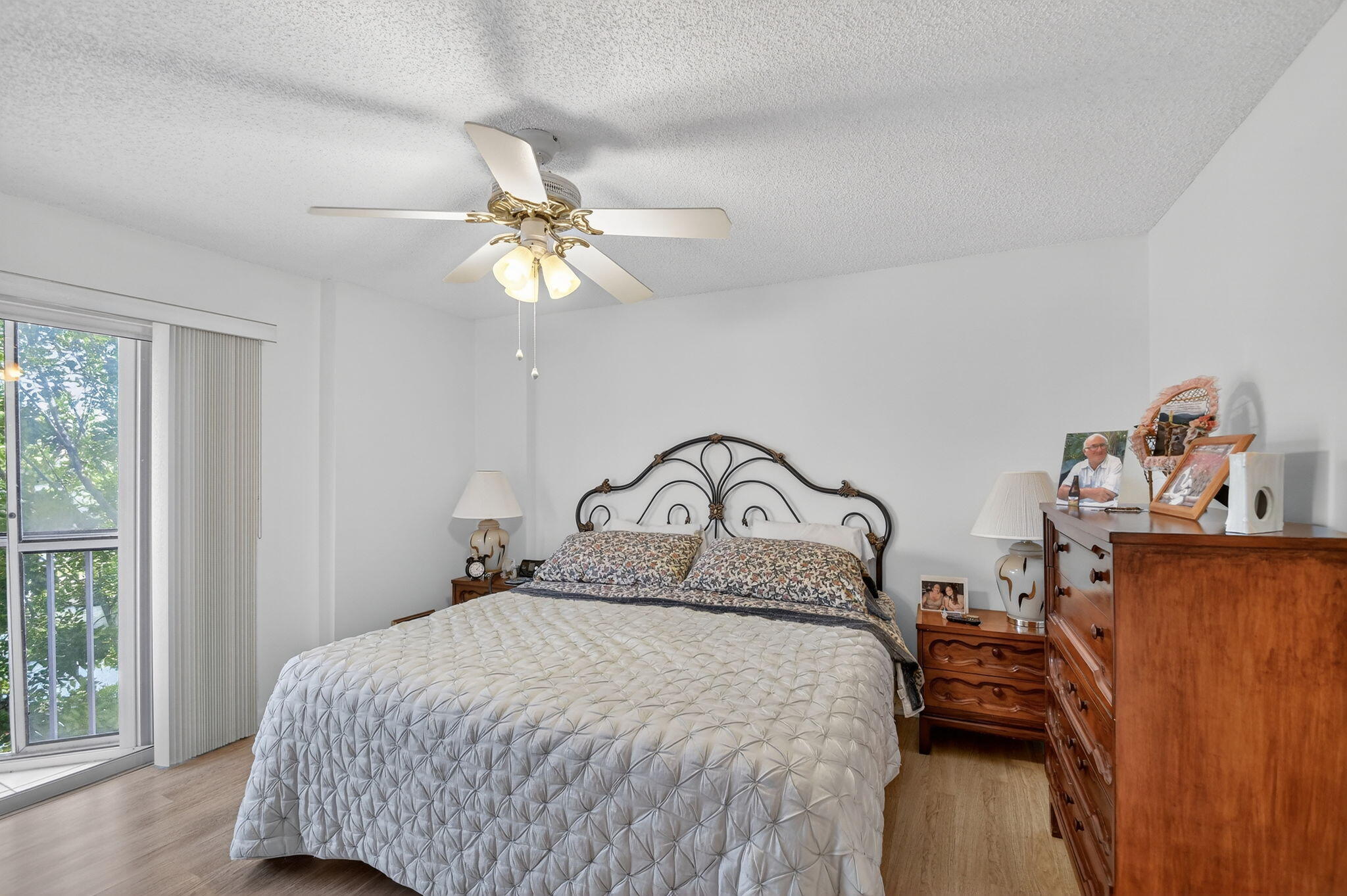 3146 Via Poinciana, Unit 301 Lake Worth, FL 33467 - Photo 15 of 23 a bedroom with a bed and a chandelier