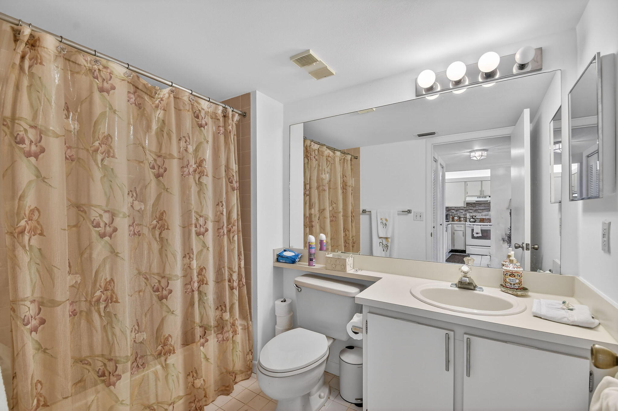 3146 Via Poinciana, Unit 301 Lake Worth, FL 33467 - Photo 19 of 23 a bathroom with a double vanity sink toilet and a mirror