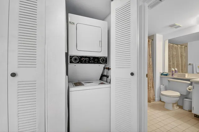 a view of bathroom with a toilet sink and mirror