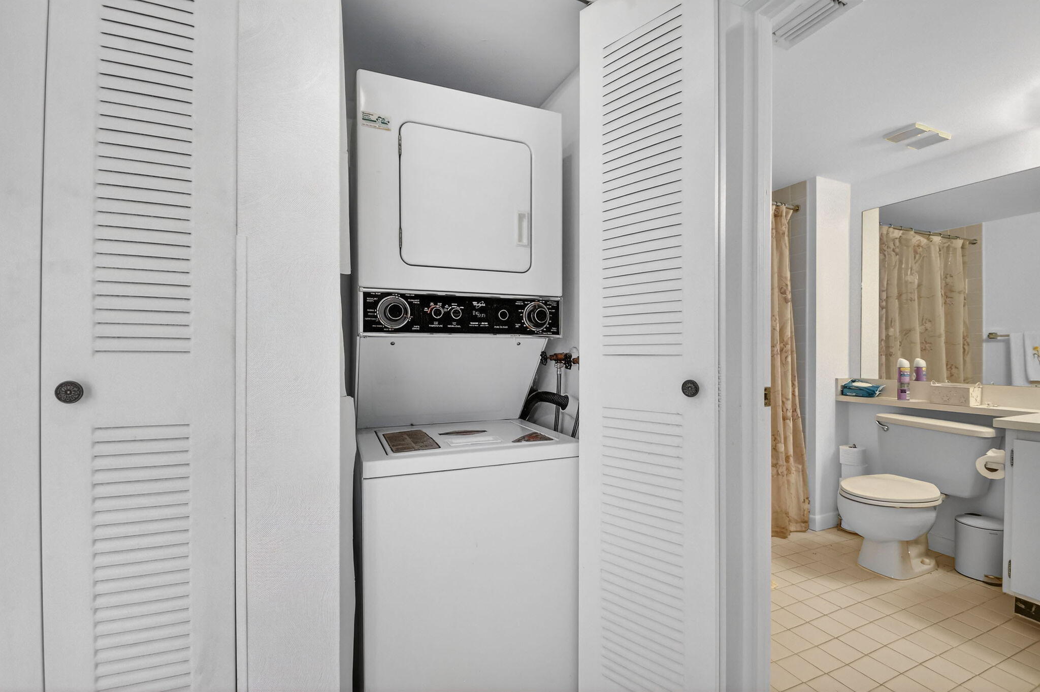 3146 Via Poinciana, Unit 301 Lake Worth, FL 33467 - Photo 20 of 23 a view of bathroom with a toilet sink and mirror
