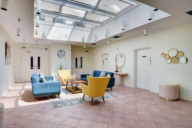 a living room with furniture and a chandelier