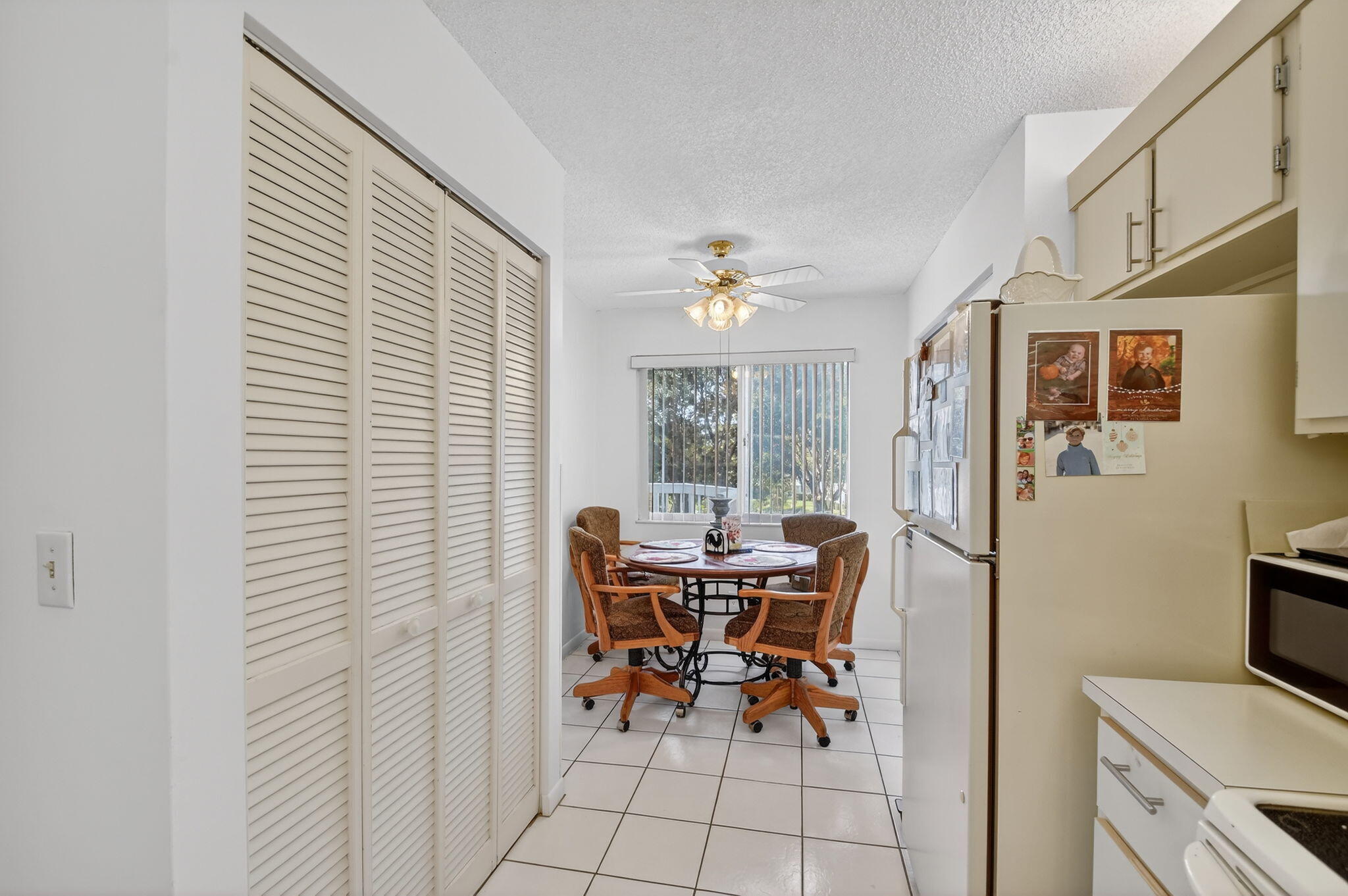3146 Via Poinciana, Unit 301 Lake Worth, FL 33467 - Photo 6 of 23 a view of a dining room with furniture and chandelier