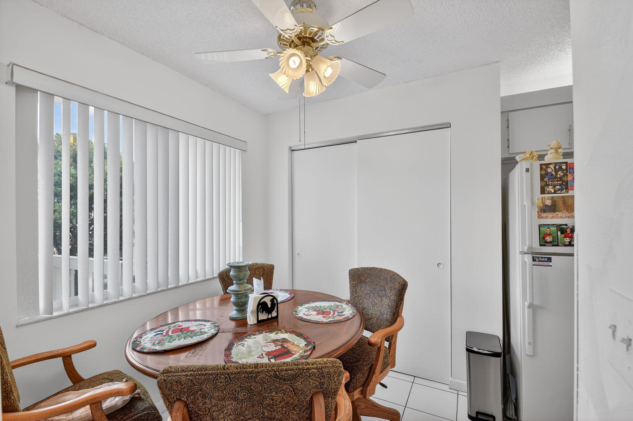 3146 Via Poinciana, Unit 301 Lake Worth, FL 33467 - Photo 7 of 23 a view of a dining room with furniture and chandelier