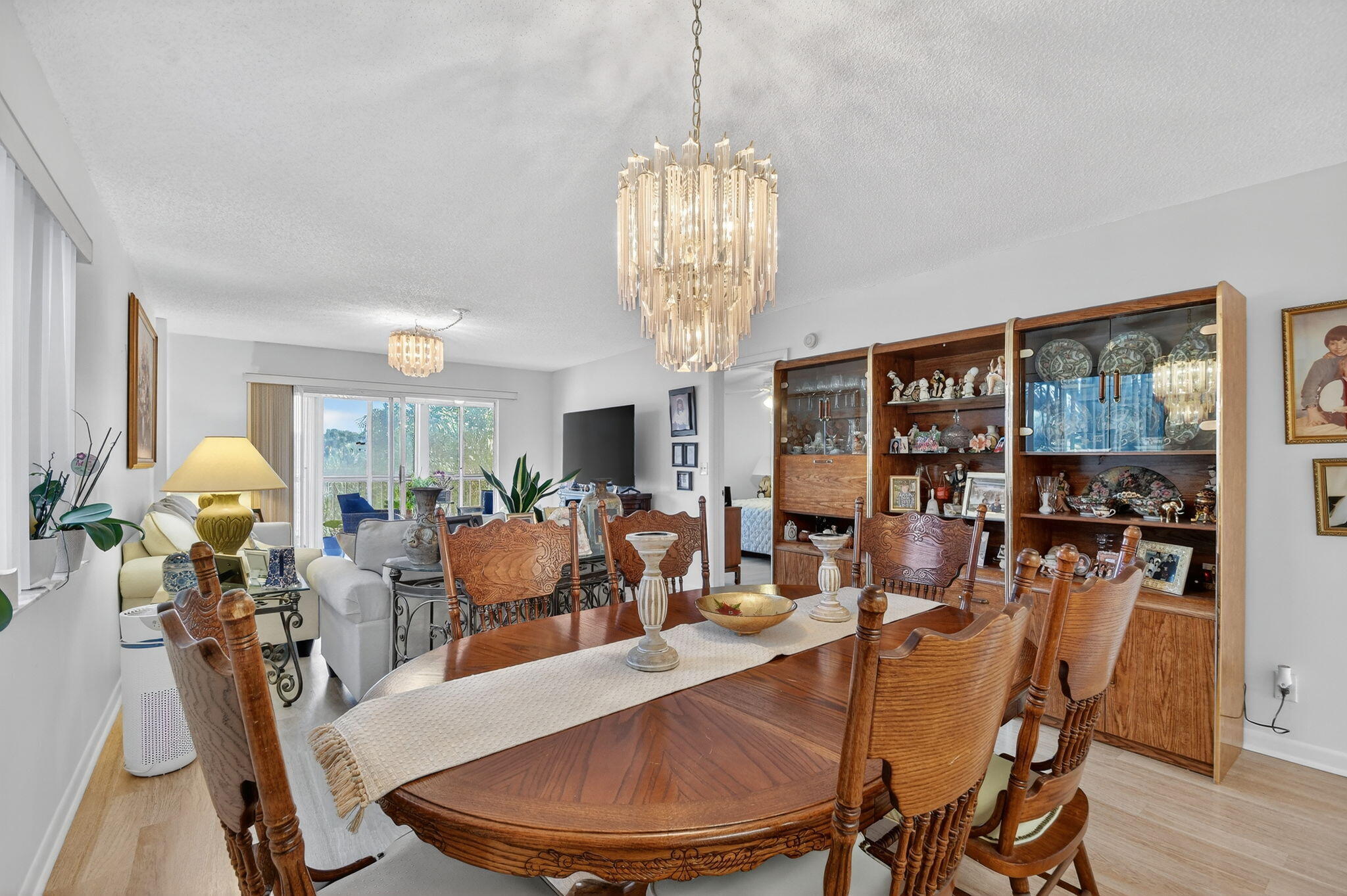 3146 Via Poinciana, Unit 301 Lake Worth, FL 33467 - Photo 10 of 23 a view of a dining room with furniture window and wooden floor
