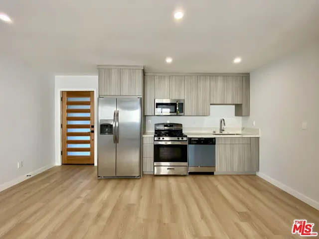 a kitchen with a sink stainless steel appliances and cabinets