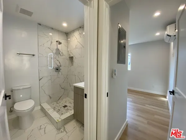 a bathroom with a toilet a sink and shower
