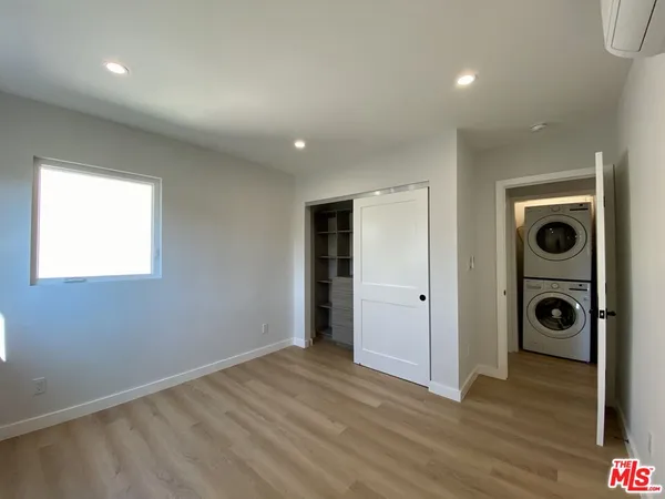 a view of a hallway with washer and dryer