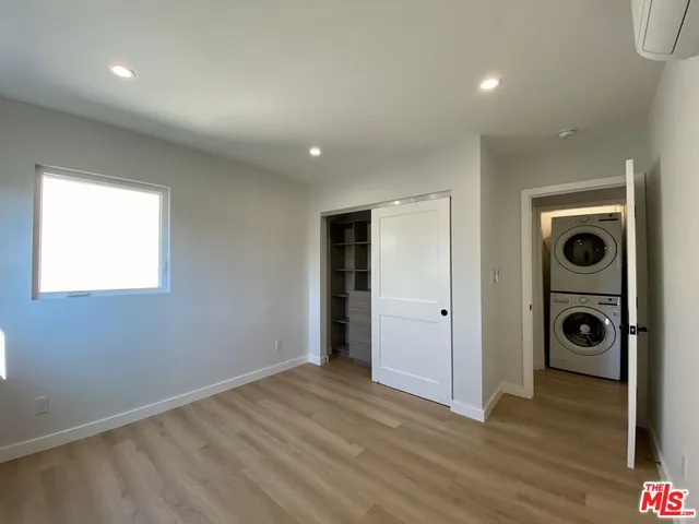 a view of a hallway with washer and dryer