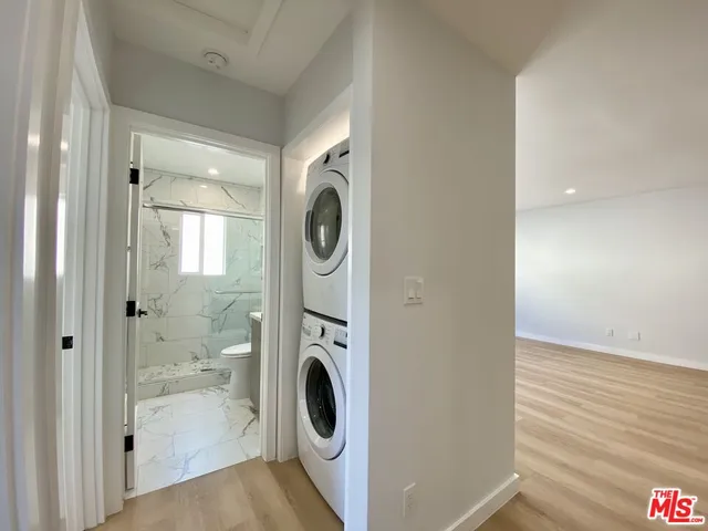a view of a hallway with washer and dryer