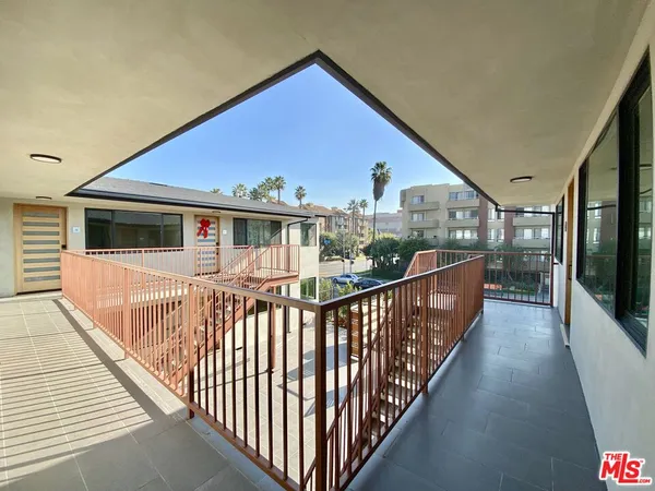 a view of a house with wooden deck