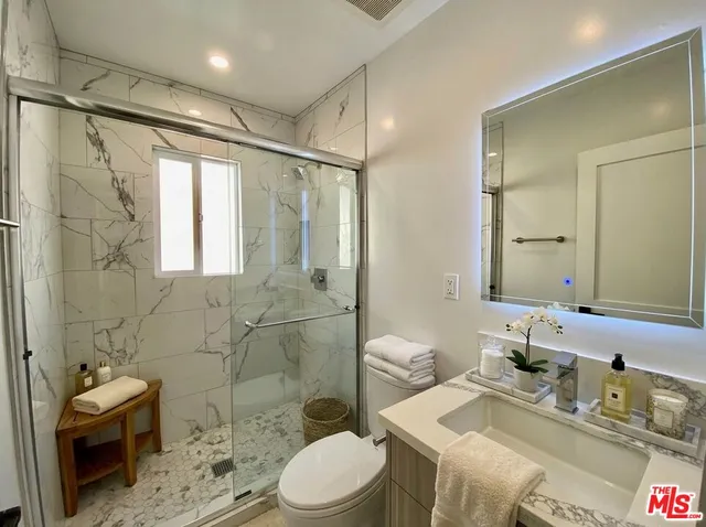 a bathroom with a sink toilet tub and shower