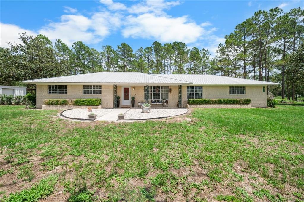 7422 County Road 231 Lake Butler, FL 32054 - Photo 1 of 57 a front view of a house with yard and green space
