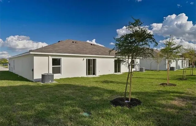 a backyard of a house with table and chairs